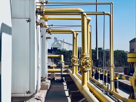 Services A detailed view of industrial pipelines in a Saudi Arabian factory setting.